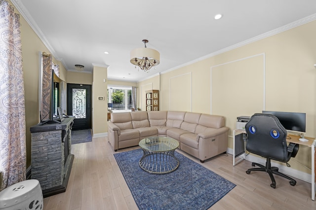 living room with light wood-type flooring, baseboards, ornamental molding, and a notable chandelier