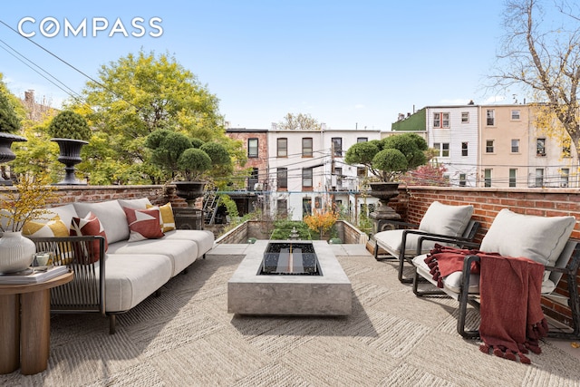 view of patio / terrace with an outdoor living space with a fire pit