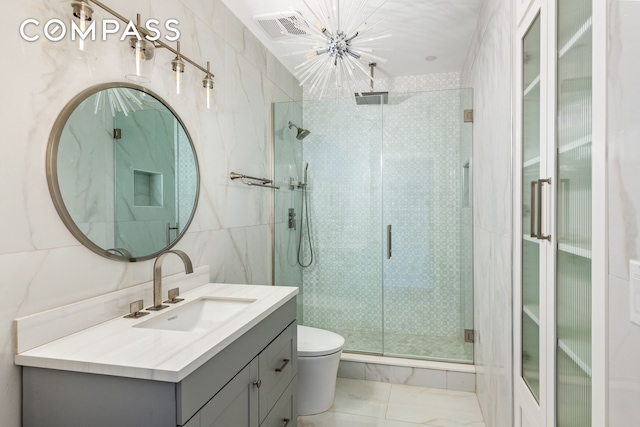 bathroom featuring visible vents, toilet, a stall shower, marble finish floor, and vanity