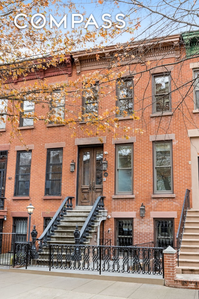 townhome / multi-family property featuring brick siding