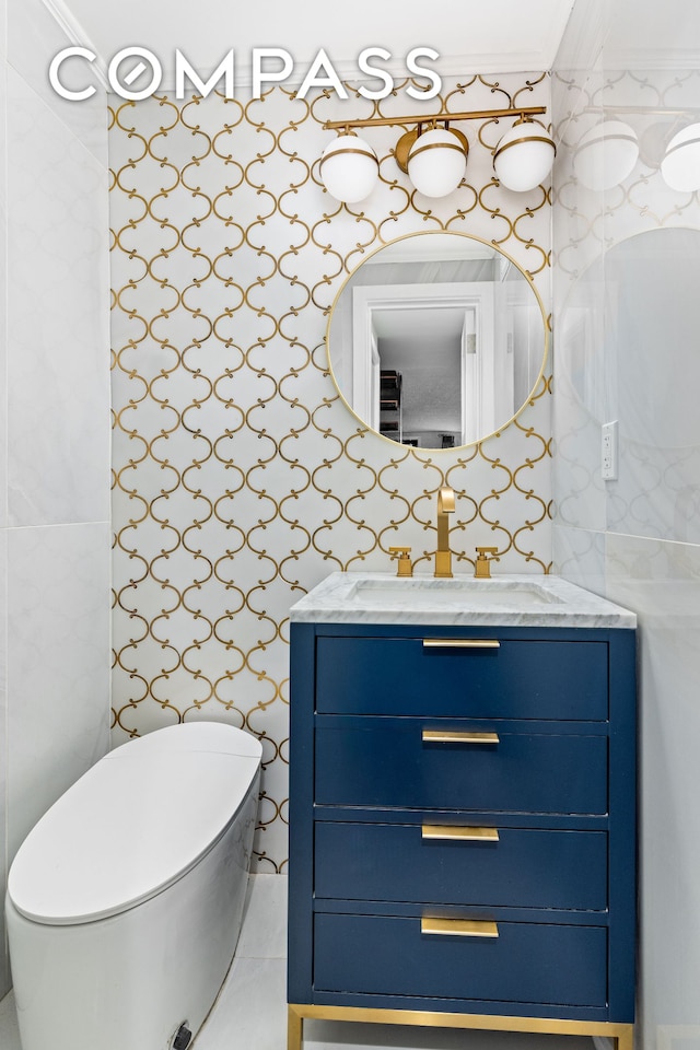 bathroom with toilet, tile walls, and vanity