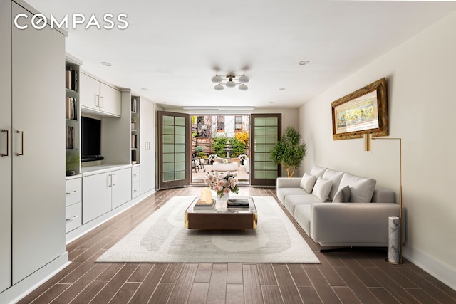 living area with baseboards and wood finish floors