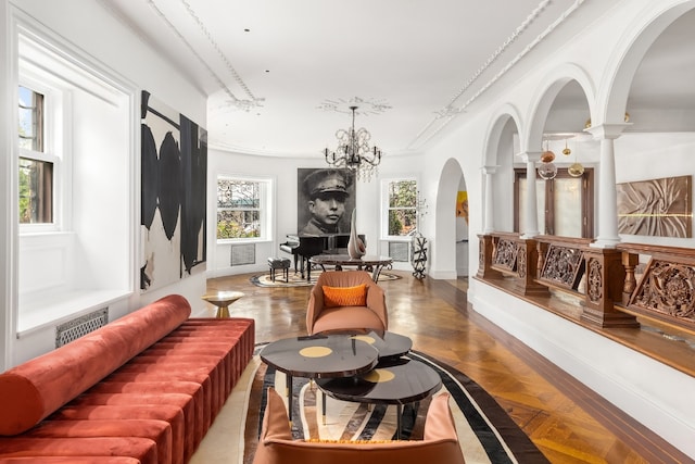 interior space with a notable chandelier, parquet flooring, and ornamental molding