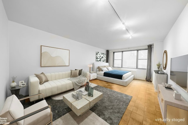 bedroom featuring rail lighting