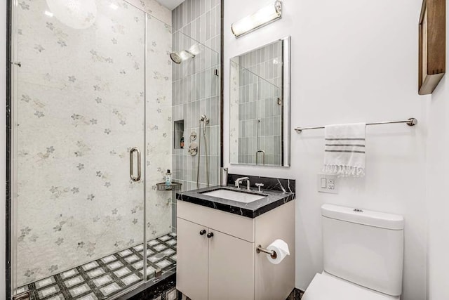 bathroom featuring toilet, walk in shower, and vanity