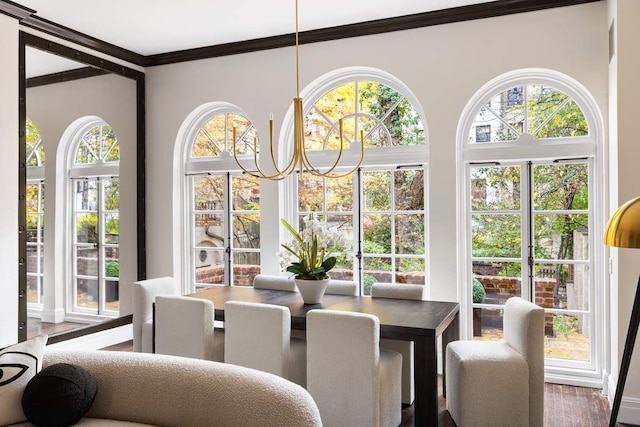 dining space with hardwood / wood-style flooring and ornamental molding