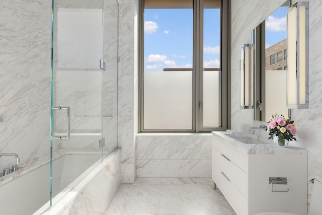 full bathroom featuring a wealth of natural light, a marble finish shower, vanity, and a tub with marble appearance