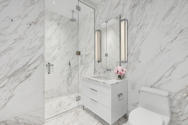 full bath featuring marble finish floor, a marble finish shower, toilet, vanity, and stone wall