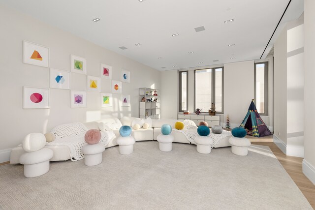 playroom featuring baseboards, light wood-style flooring, and recessed lighting