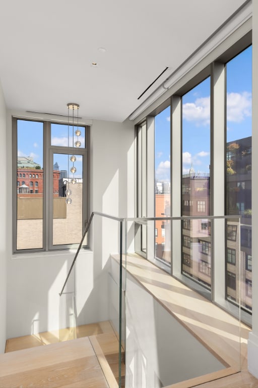 corridor featuring expansive windows and a healthy amount of sunlight