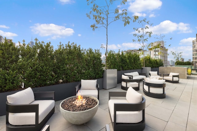 view of patio / terrace featuring an outdoor living space with a fire pit