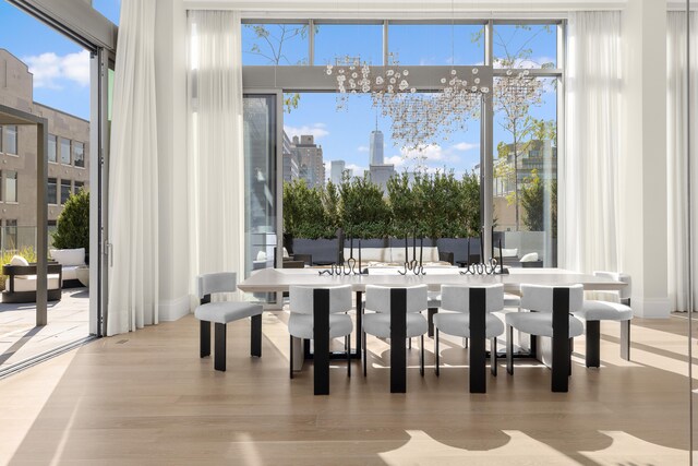 dining room featuring a view of city and wood finished floors