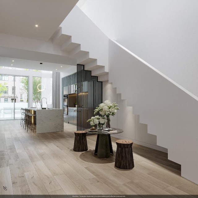 stairway with hardwood / wood-style flooring and sink