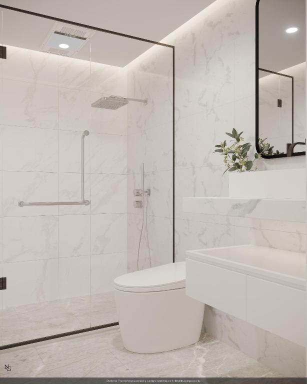 bathroom featuring walk in shower, toilet, and tile walls