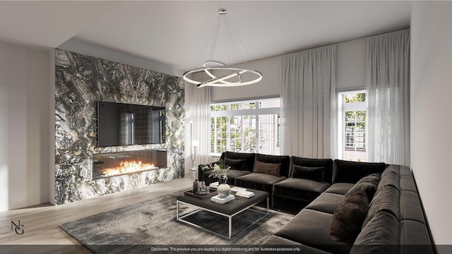 living area featuring a chandelier, a premium fireplace, and wood finished floors