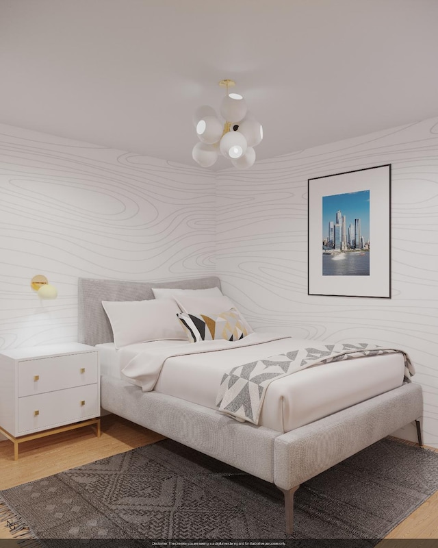 bedroom with a chandelier and wood finished floors