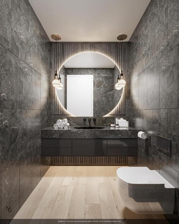 bathroom with tile walls, vanity, and toilet