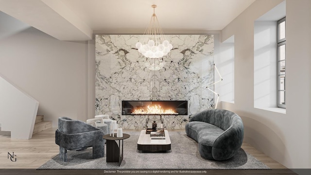 living area featuring wood-type flooring, a premium fireplace, and a chandelier