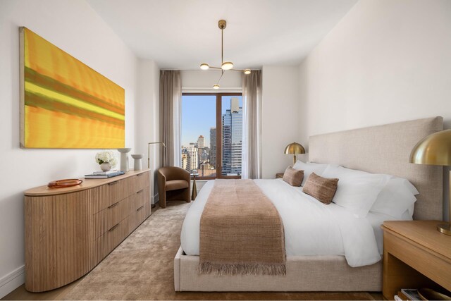 bedroom with a city view and light colored carpet