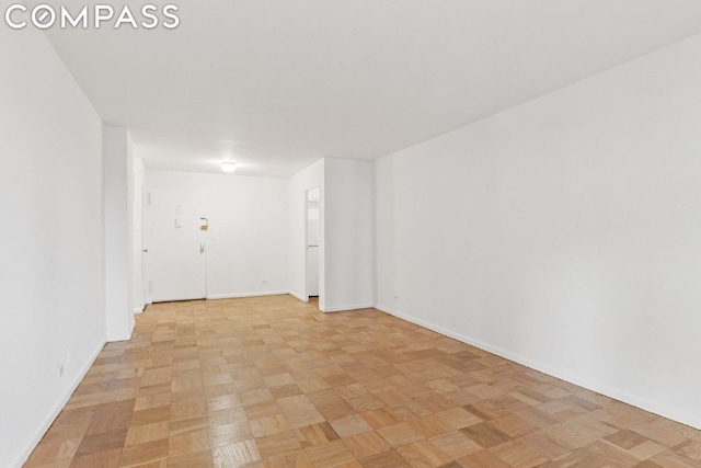 unfurnished room with light parquet floors