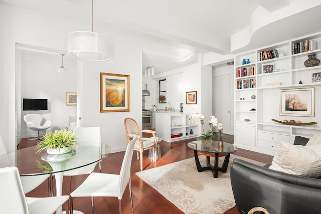 interior space featuring built in shelves and dark hardwood / wood-style flooring