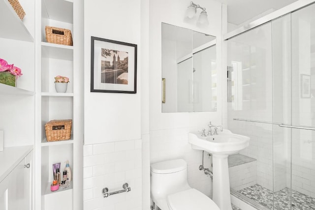 bathroom featuring an enclosed shower and toilet