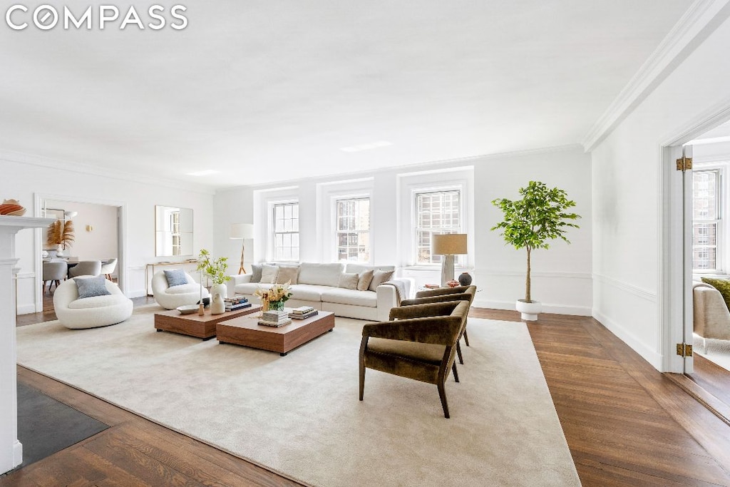 living room with crown molding and wood-type flooring