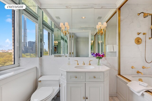 bathroom with shower / bath combination, toilet, a view of city, crown molding, and vanity