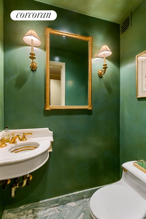 bathroom with visible vents, a sink, and toilet