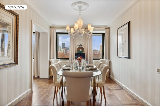 dining area featuring a chandelier, crown molding, baseboards, and wallpapered walls