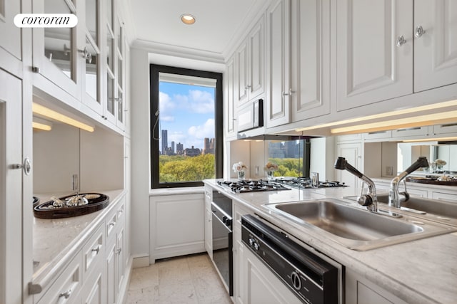 kitchen featuring glass insert cabinets, white cabinetry, and a sink