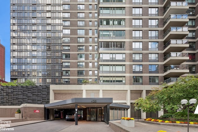 view of property featuring covered parking