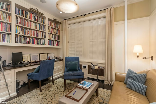 61 E 86th St Unit 6, New York City, NY 10028 - home office featuring built in desk, built in shelves, a decorative wall, and wood finished floors