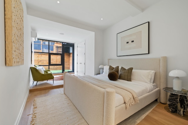 bedroom featuring light wood-style flooring, baseboards, access to outside, and recessed lighting