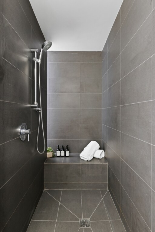 bathroom with tiled shower