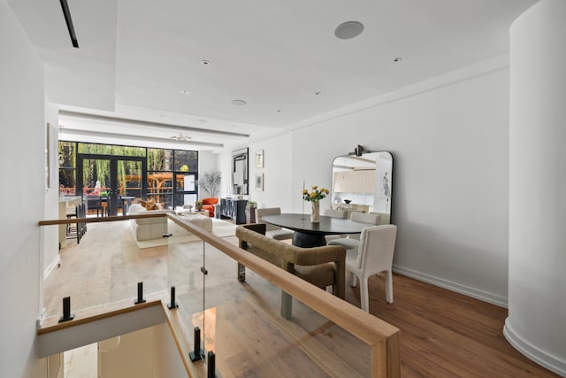 dining area with french doors, baseboards, and wood finished floors