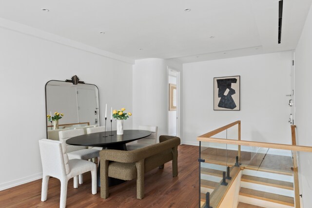 dining area featuring dark wood-style floors and baseboards