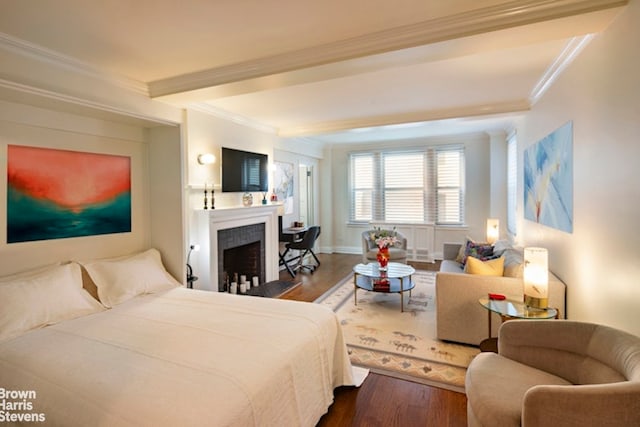 bedroom featuring hardwood / wood-style floors and crown molding