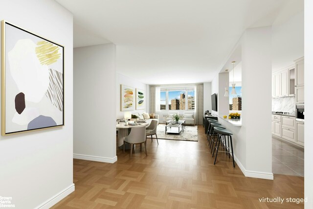 spare room with ceiling fan, radiator, and light parquet floors