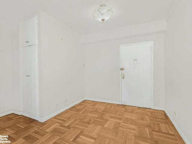 unfurnished room with crown molding and baseboards