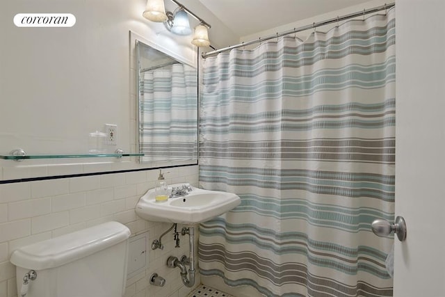 bathroom featuring tile walls, toilet, and a shower with curtain