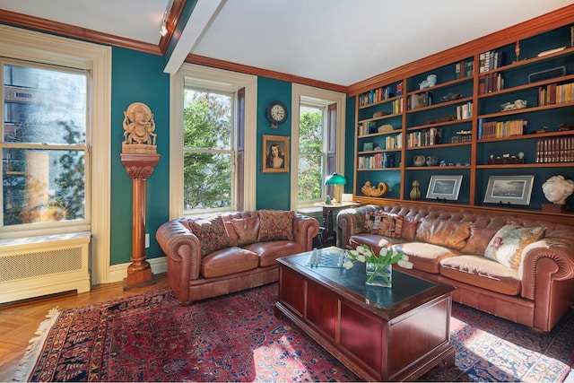 living room with ornamental molding, radiator, and baseboards