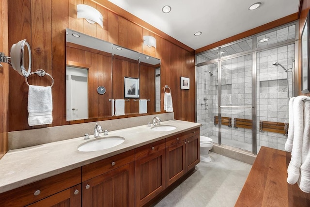 bathroom with a stall shower, a sink, wooden walls, and double vanity