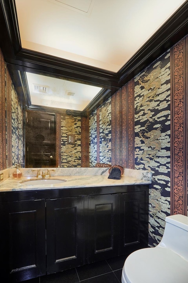 bathroom featuring toilet, visible vents, vanity, tile patterned floors, and wallpapered walls