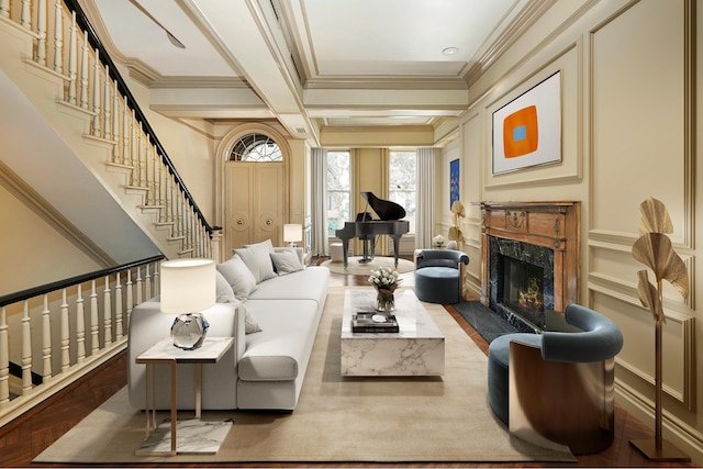 interior space with stairway, a fireplace, ornamental molding, and beamed ceiling