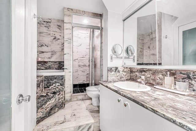 full bathroom featuring toilet, vanity, marble finish floor, and a shower stall