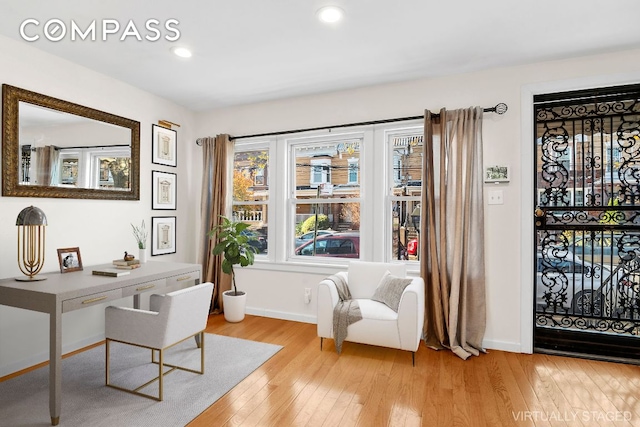 home office with light hardwood / wood-style floors