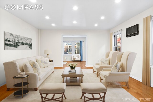 living room with light hardwood / wood-style floors and a wealth of natural light