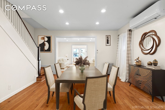 945 E 32nd St, New York City, NY 11210 - dining space with a wall mounted AC, light wood-style floors, stairs, recessed lighting, and baseboards