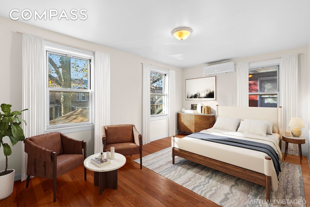 945 E 32nd St, New York City, NY 11210 - bedroom with a wall mounted air conditioner and wood finished floors